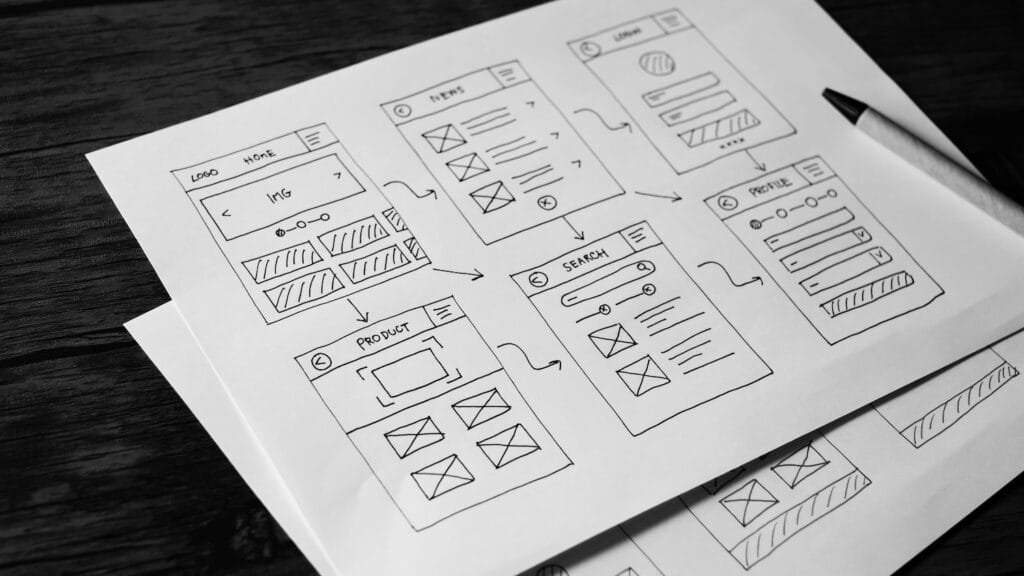 Custom web design stratefy Wireframes sketched on a notepad.