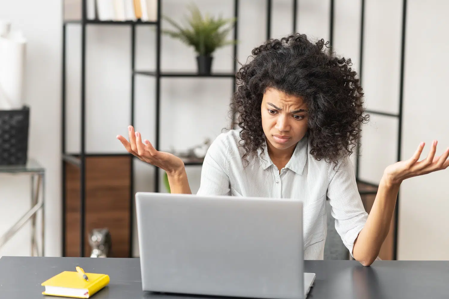 Woman frustrated at the webside design and poor navigation.